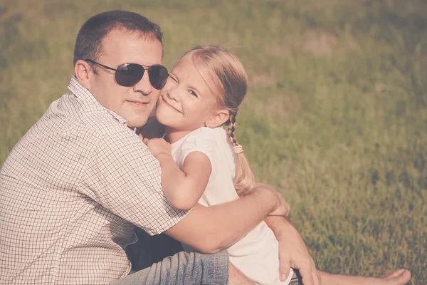Father and daughter playing on the grass at the day time. — Stock Photo, Image