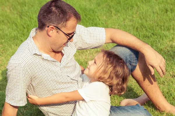 Father and son playing on the grass at the day time. — Stock Photo, Image