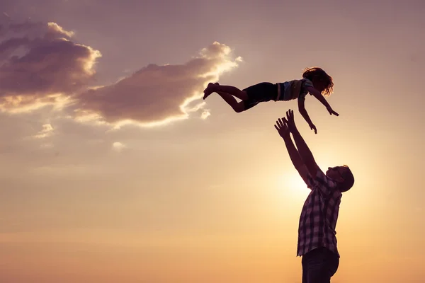 Father and son playing on the beach at the sunset time. — Stock Photo, Image