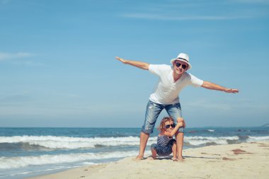 Baba ve oğul plaj gün anda oynamak.