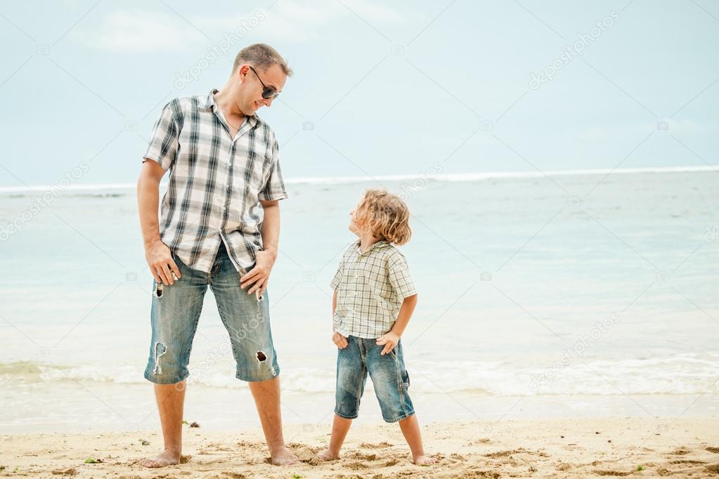 Father and son playing on the beach at the day time.