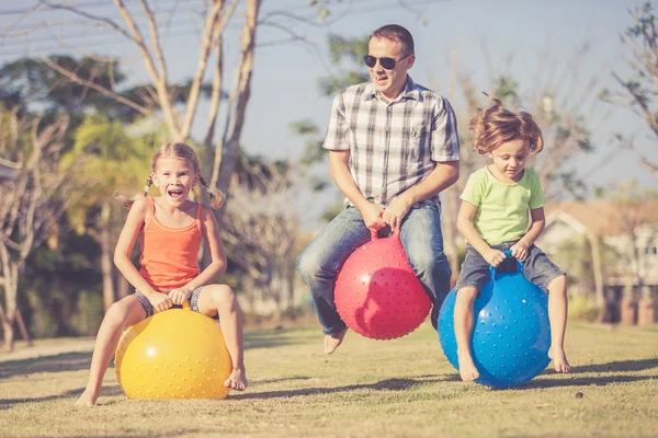 Dad and children playing on the lawn in front of house — Stock Photo, Image