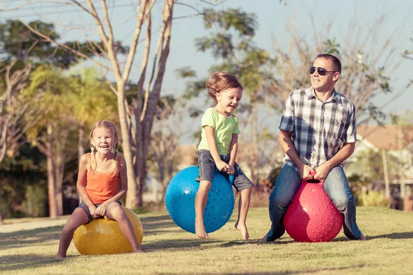 Papa und Kinder spielen auf dem Rasen vor dem Haus — Stockfoto