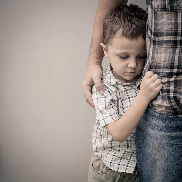 Triste figlio che abbraccia suo padre Fotografia Stock