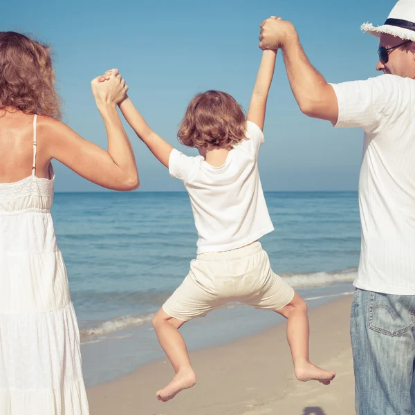 Glückliche Familie, die tagsüber am Strand spazieren geht. — Stockfoto