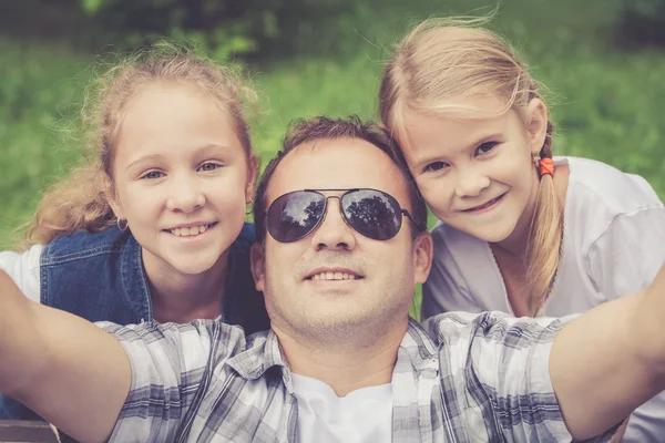 Father and daughters  playing at the park at the day time. — Stock Photo, Image