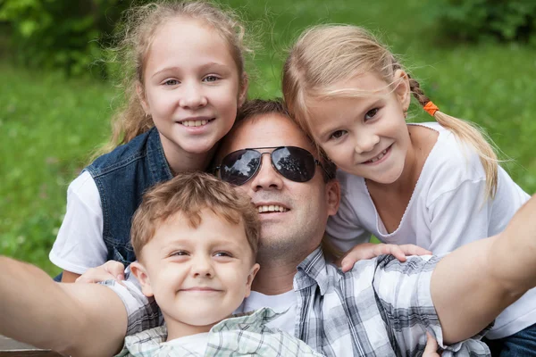 Father and children playing at the park — Stock Photo, Image