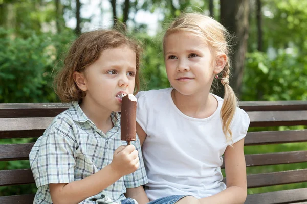 Dwa szczęśliwe dzieci bawiące się w parku w czasie dnia. — Zdjęcie stockowe