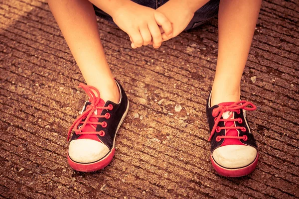 Youth sneakers on boy legs on road — Stock Photo, Image