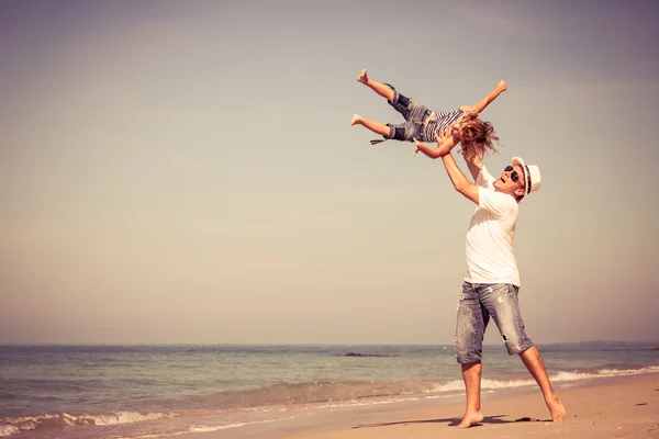 Padre e figlio che giocano sulla spiaggia durante il giorno . — Foto Stock