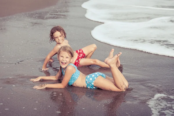 Sister and brother playing on the beach at the day time. — Stock Photo, Image