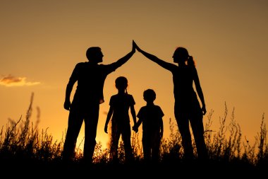 Happy family standing in the park. clipart