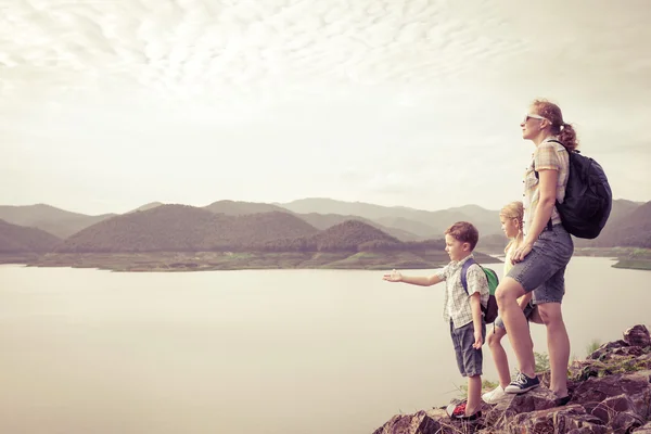 Família feliz de pé perto do lago . — Fotografia de Stock