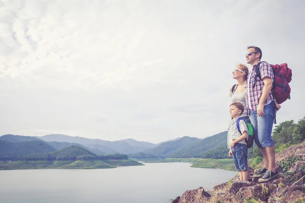 Happy family standing near the lake. — Stock Photo, Image