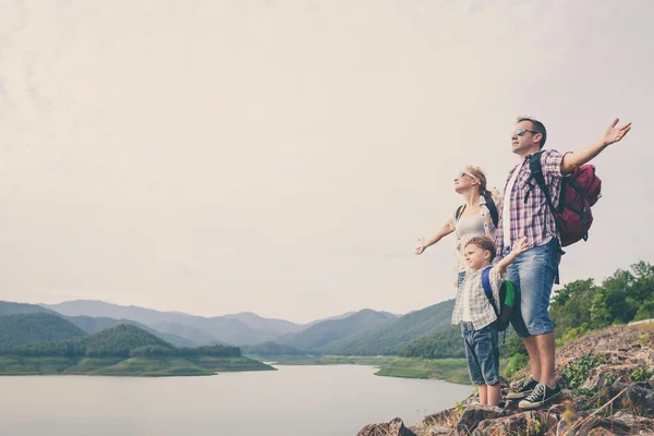 Happy family standing near the lake. — Stock Photo, Image