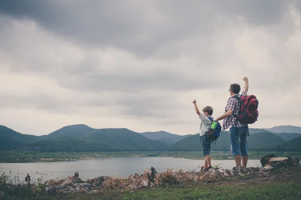 Father and son standing near the lake. — Stock Photo, Image