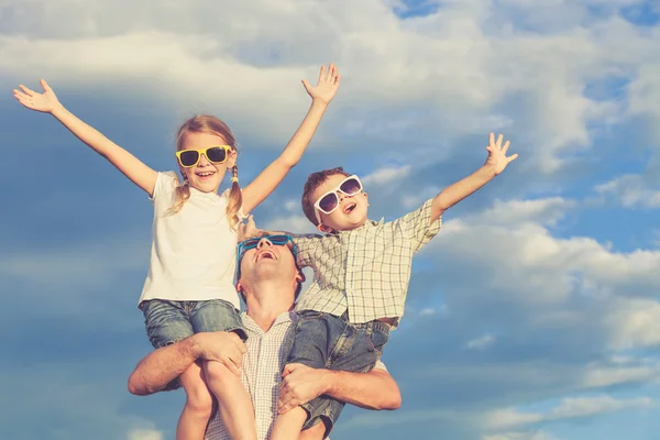 Father and children playing in the park  at the day time. — Stock Photo, Image