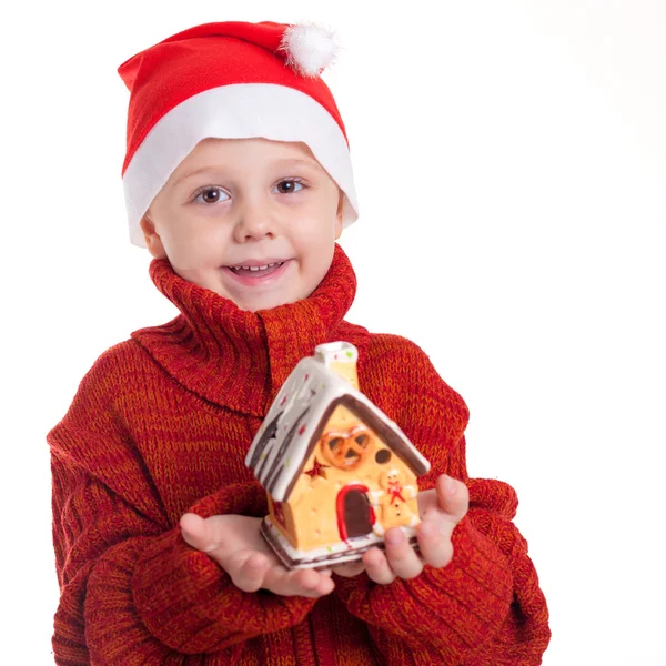 Glad liten leende pojke med jul hatt. — Stockfoto