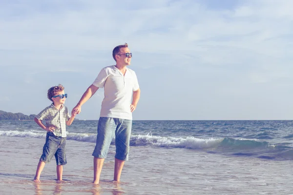 Isä ja poika leikkivät rannalla päivällä. . — kuvapankkivalokuva