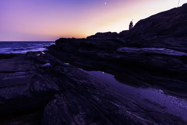 Pôr do sol em uma costa rochosa . — Fotografia de Stock