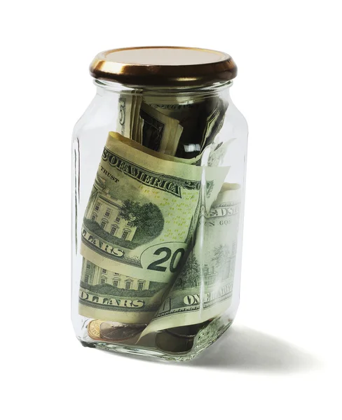 Ons dollar biljetten en munten in glazen pot — Stockfoto