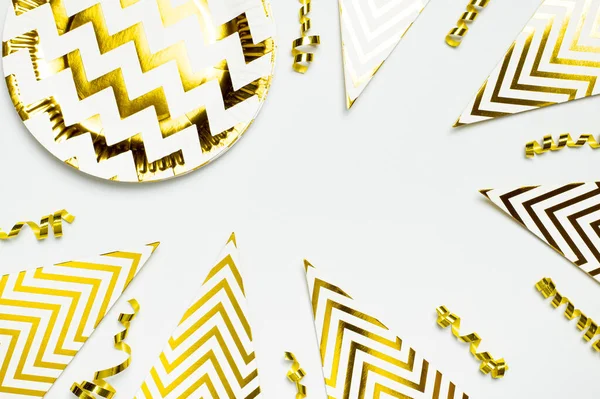 Festive white and gold paper fans, gold confetti for party, birthday, holiday, wedding on light background top view. Origami. Decorative objects. Colorful abstract background. Festive trendy backdrop