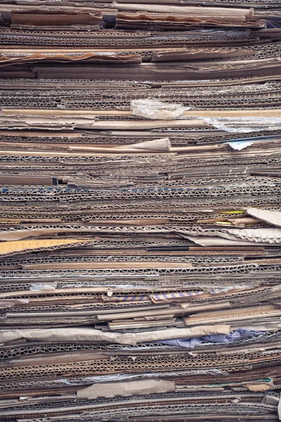 Used corrugated paper in a pile. Collection of waste paper. Waste recycling and environmental preservation.