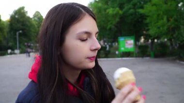 genç bir kız parkta bir dondurma yemek