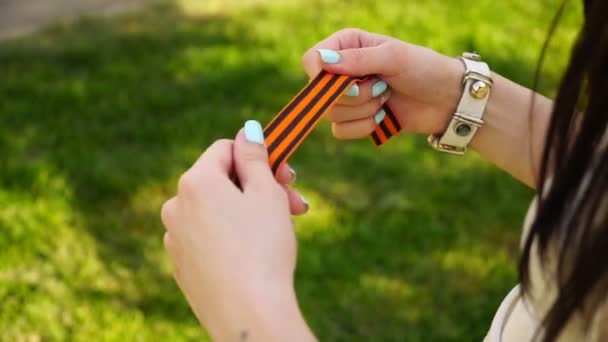 Girl holding a St. George ribbon outdoors — Stock Video