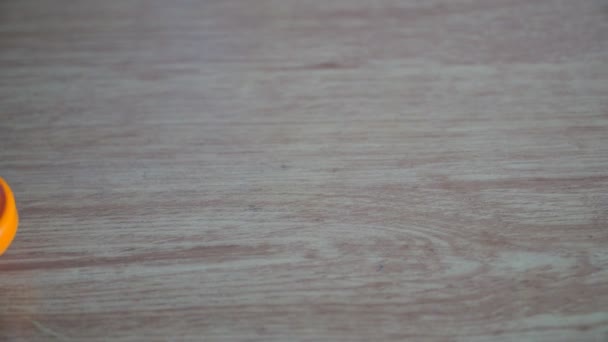 orange pinwheel spinning on a table