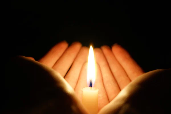 Burning candle in the hands — Stock Photo, Image