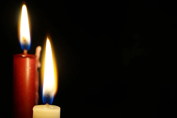 Burning candle isolated on black — Stock Photo, Image