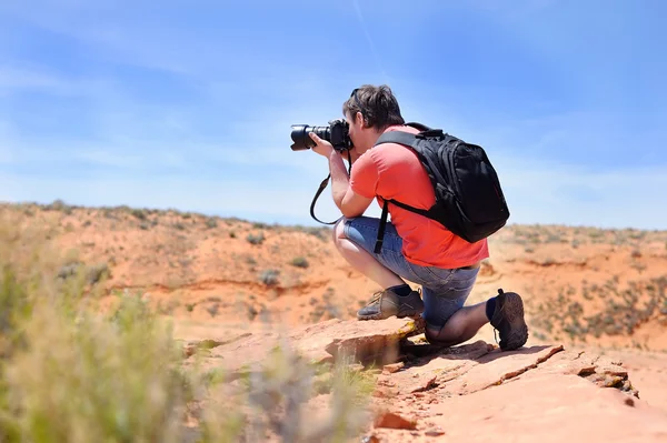Photographer taking photo with professional digital camera — Stock Photo, Image