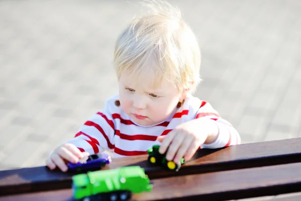 Toddler boy playing with toy cars — Stock Photo, Image