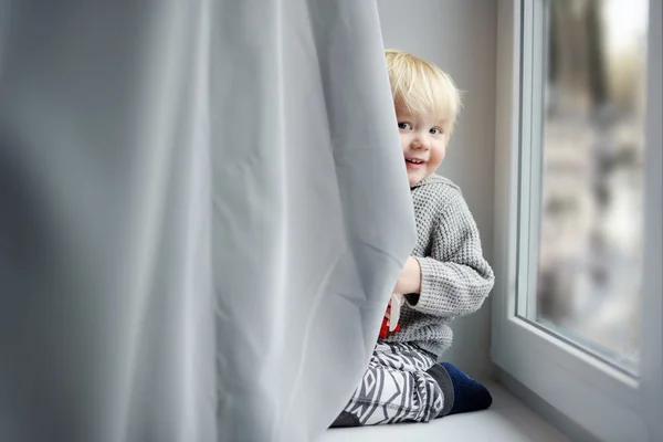 Småbarn pojke på fönsterbrädan — Stockfoto