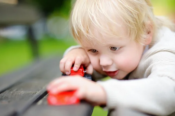 Toddler boy playing with toy cars — Stock Photo, Image