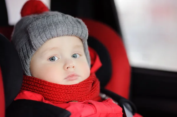 Close up portrait of toddler boy sitting in car seat — Stock Photo, Image