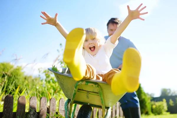 Happy Little Boy Having Fun Wheelbarrow Pushing Dad Domestic Garden — Stock Photo, Image