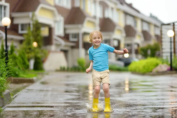 Little Boy Wearing Yellow Rubber Boots Jumping Puddle Water Rainy — Stock Photo, Image