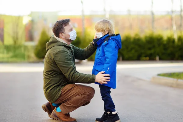 Father Wearing Protective Mask Puts Face Mask His Little Son — Stock Photo, Image