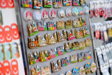 Sale of magnets, postcards, bottle openers, bookmarks, calendars, key rings and other souvenirs on the street of Istanbul. Gift and keepsakes for self, friends and relative from travels by Turkey.
