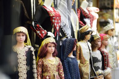 Mannequins dressed in national clothes are displayed in front of a store in Istanbul, Turkey. Gorgeous authentic pashminas, dresses, caftans for children and adults.