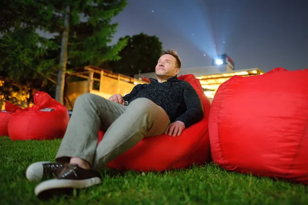 Mature Man Laying Pillow Grass Watching Movie Outdoor Cinema Public — Stock Photo, Image