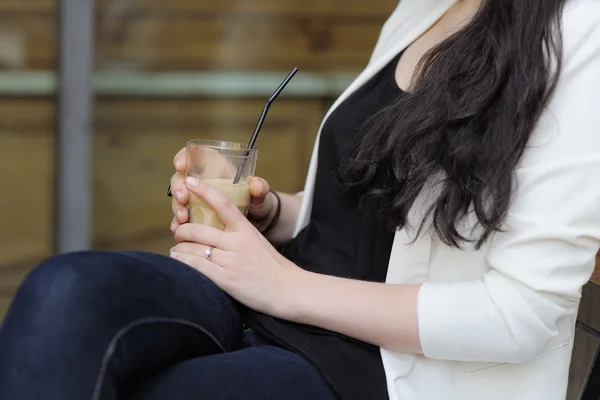 Woman holding glass with coffee — Stock Photo, Image