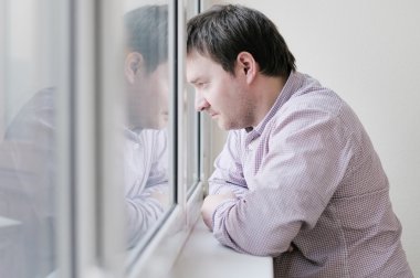 Man looking at the window clipart