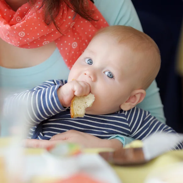 Baby boy having piece of bread — Stock Photo, Image