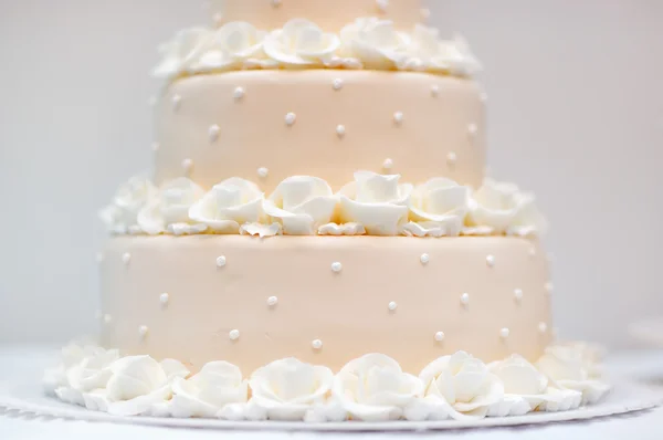 Delicious peach and white wedding cake