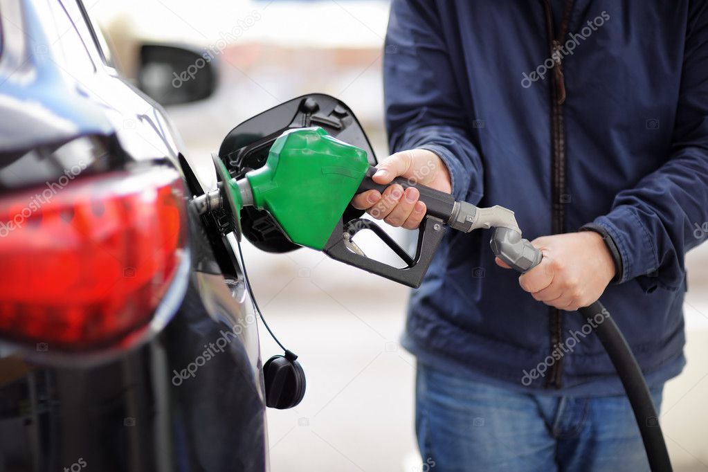 Pumping gas at gas pump 