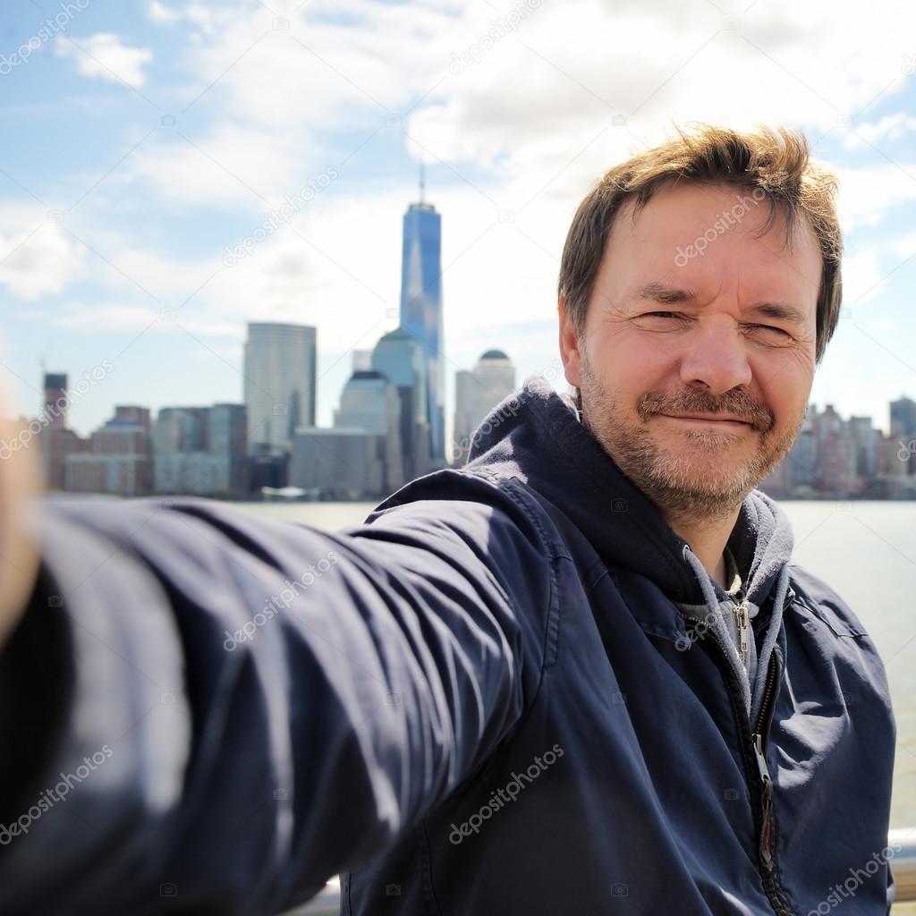 Happy tourist taking a self portrait in New York City