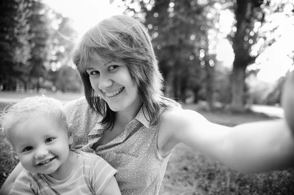 Happy family at park making selfie Stock Photo